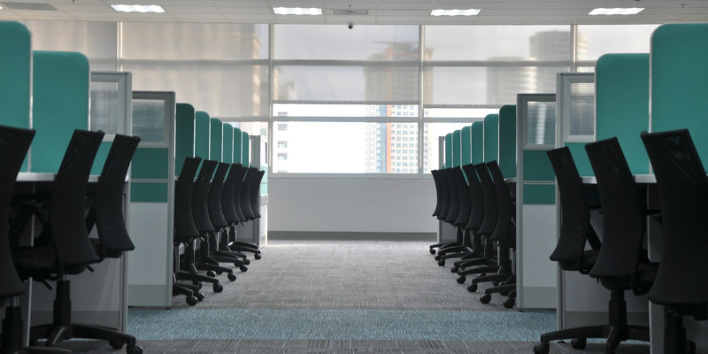 Dozens of cubicles in a depressing office. Photo by kate.sade on Unsplash.